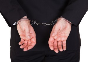 Man in business suit handcuffed 