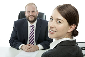 Manager and employee smiling during a performance review 