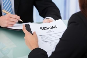 Employer looking at a candidate's resume during interview 