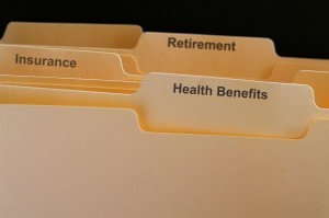 File folders representing health benefits, insurance, and retirement