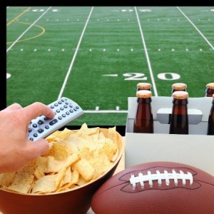 Watching football on TV with chips and drinks